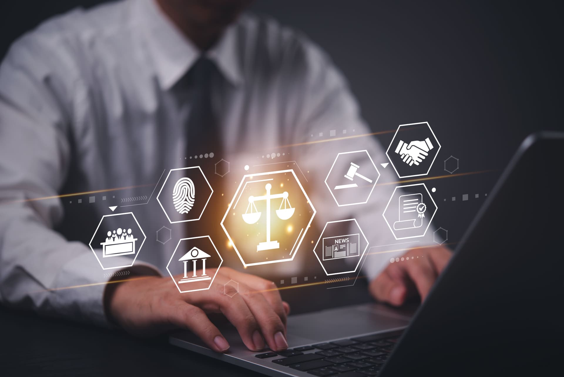 Business professional typing on a laptop with digital icons floating in front, including scales of justice, fingerprint, handshake, gavel, and courthouse, symbolizing law and legal technology.